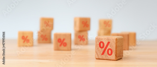 Interest rate financial and mortgage rates concept. Wooden cube block with icon percentage symbol
