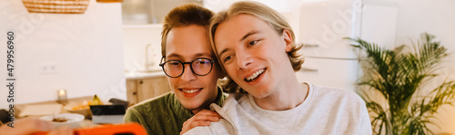 European gay couple hugging and smiling while spending time together
