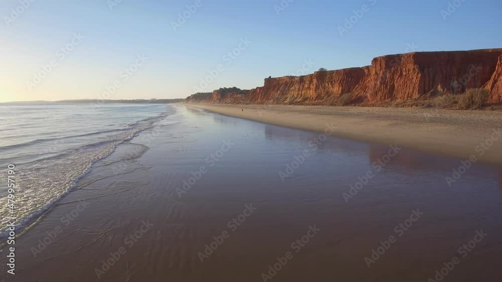 Aerial flight, over a beautiful evening beach at low tide, and a mirrored surface that reflects the sky. Aerial flight, over a beautiful evening beach at low tide, and a mirrored surface that reflects the sky.