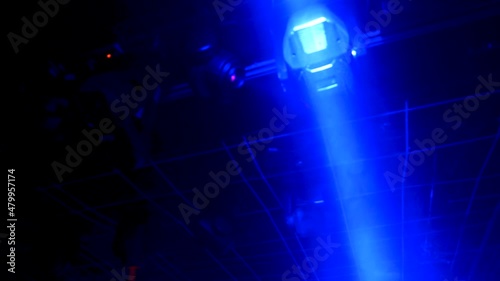 robotic blue lasers lighting up a nightclub dance floor