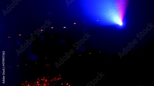 robotic laser and light play on the roof of a club