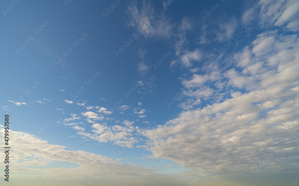 Obraz premium Clear blue sky with white fluffy clouds at noon. Day time. Abstract nature landscape background.