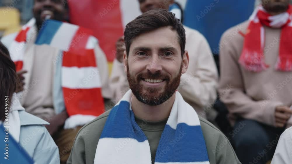 Happy man waving with french flag during soccer game