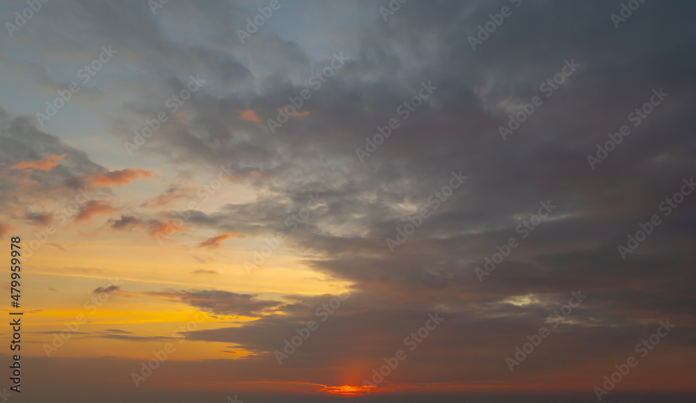 Sunset sky. Abstract nature background. Dramatic blue with orange colorful clouds in twilight time. Sunset sky. Abstract nature background. Dramatic blue with orange colorful clouds in twilight time.