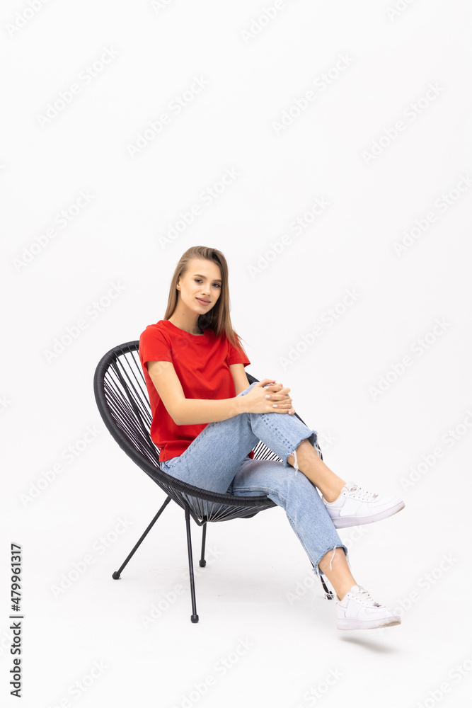 Young pretty woman sitting in armchair on white background Young pretty woman sitting in armchair on white background