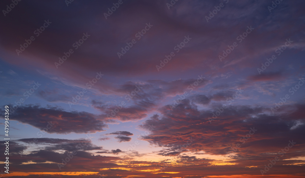 Sunset sky. Abstract nature background. Dramatic blue with orange colorful clouds in twilight time. Sunset sky. Abstract nature background. Dramatic blue with orange colorful clouds in twilight time.