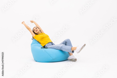 Young pretty woman sit in bag chair look camera isolated on white background. People lifestyle concept