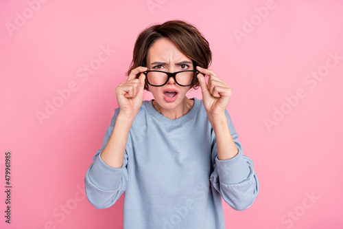 Photo of sad young brunette lady look camera wear eyewear blue sportscloth isolated on pink color background