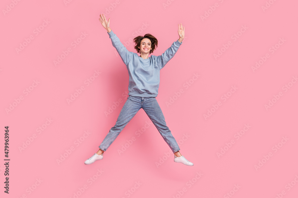 Full body photo of hooray millennial lady jump up wear pullover jeans footwear isolated on pink background