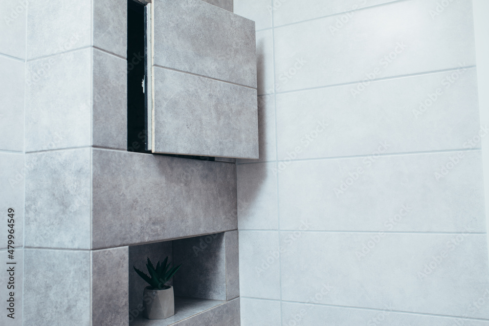 Obraz premium Hidden revision sanitary hatch on the wall of bathroom.