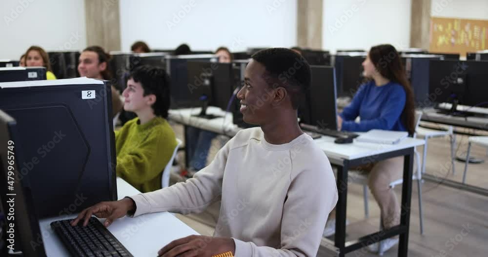 Young multiracial people using computers inside school classroom at university Young multiracial people using computers inside school classroom at university