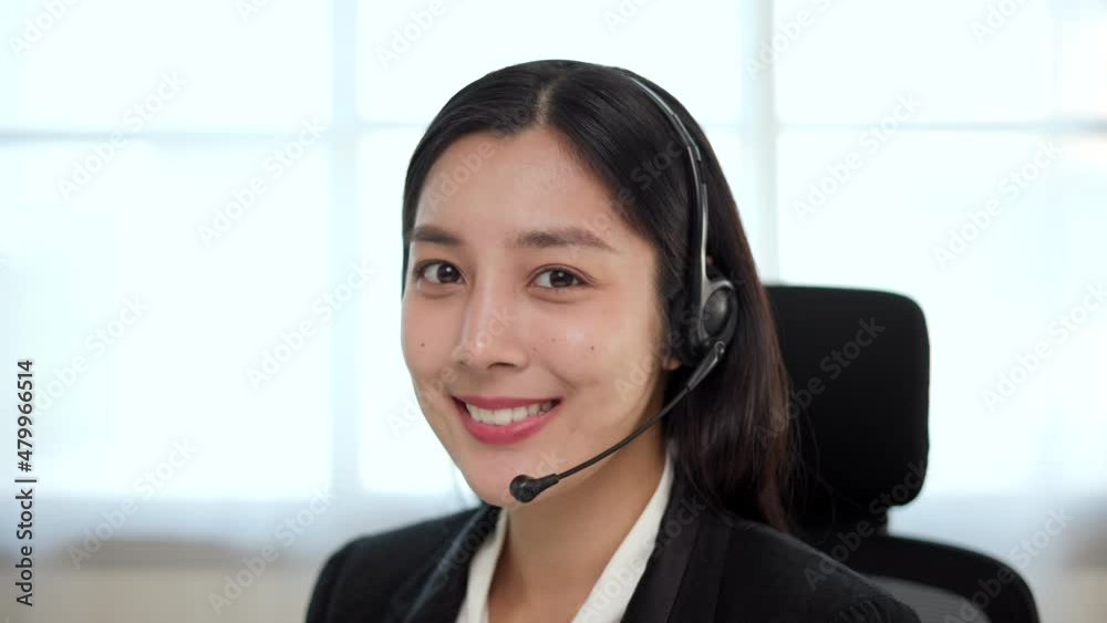 Call center smiley asian business woman receptionist wear headphone video conference calling on computer talk by webcam in online chat, customer support service. Call center smiley asian business woman receptionist wear headphone video conference calling on computer talk by webcam in online chat, customer support service.
