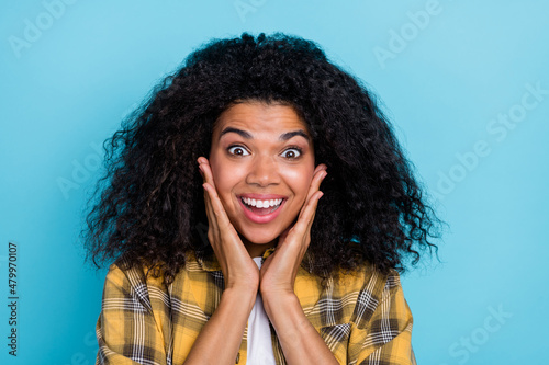Photo of funny lady hands cheeks omg wow reaction crazy face wear checkered shirt isolated blue color background © deagreez