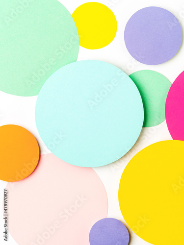 Minimal geometric shapes background in pastel pink, blue, yellow and green colours. Abstract bright colored paper circles. Creative concept, layout, template for styling and design. Space for text.
