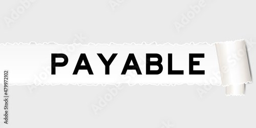 Ripped gray paper background that have word payable under torn part