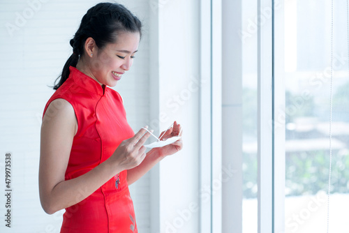 Woman in Chinese tradition dress to celebrate the new year, lookin at medical mask, prevent the spread of COVID-19 Free Download Woman in Chinese tradition dress to celebrate the new year, lookin at medical mask, prevent the spread of COVID-19 - GFXLoad