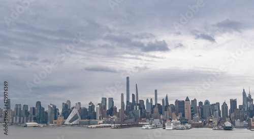 boats in the harbor, manhattan skyline during an overcast day.