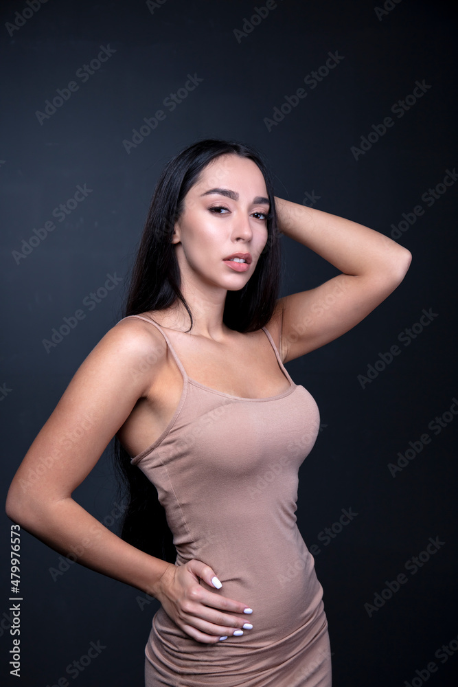 portrait of a young woman in the studio on a dark background portrait of a young woman in the studio on a dark background