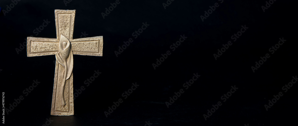 Religious cross with black background and copy space for condolence text on the right side of the images. Condolence and sympathy concept. Religious cross with black background and copy space for condolence text on the right side of the images. Condolence and sympathy concept.