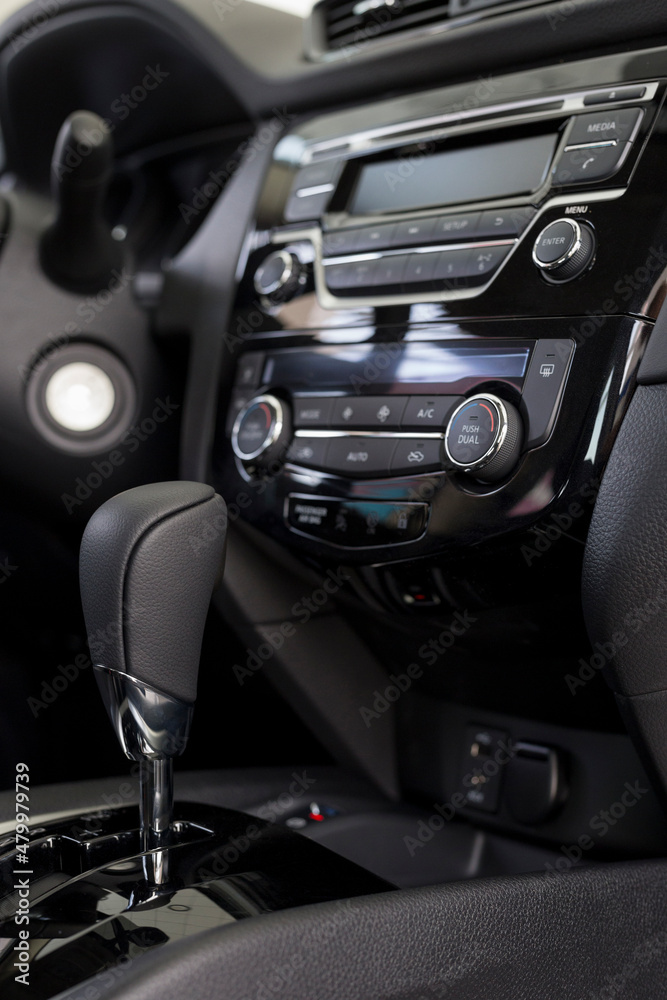 Interior of new modern unknown car with automatic transmission in dealer showroom. Modern transportation.