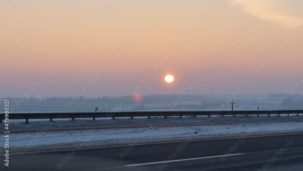 Winter landscape in snow nature with sun, field and trees. Magical winter sunset in a snow field. Winter landscape in snow nature with sun, field and trees. Magical winter sunset in a snow field.