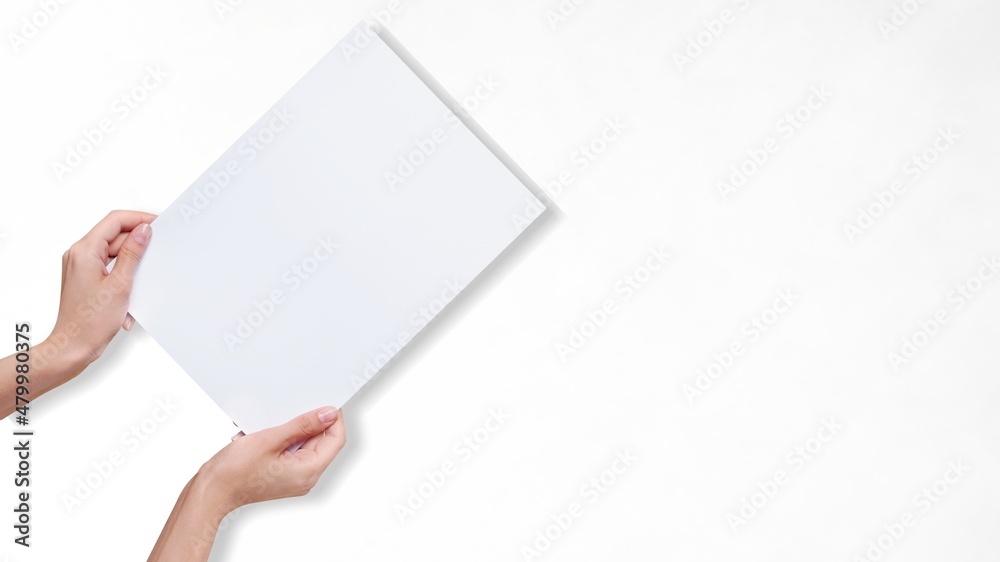 Hands holding white paper blank for a letter paper Hands holding white paper blank for a letter paper