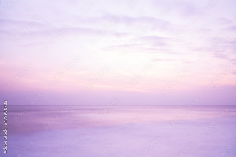 Beautiful long exposure seascape of smooth wavy sea and cloud. Pink horizon with first sunset sky.