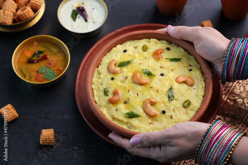 Ven Pongal Khara Pongal Sambar coconut chutney woman hand serving Indian breakfast food Tamil Nadu festival Pongal Sankranti Diwali spicy pongal using rice lentil semolina rava South India Sri Lanka photo