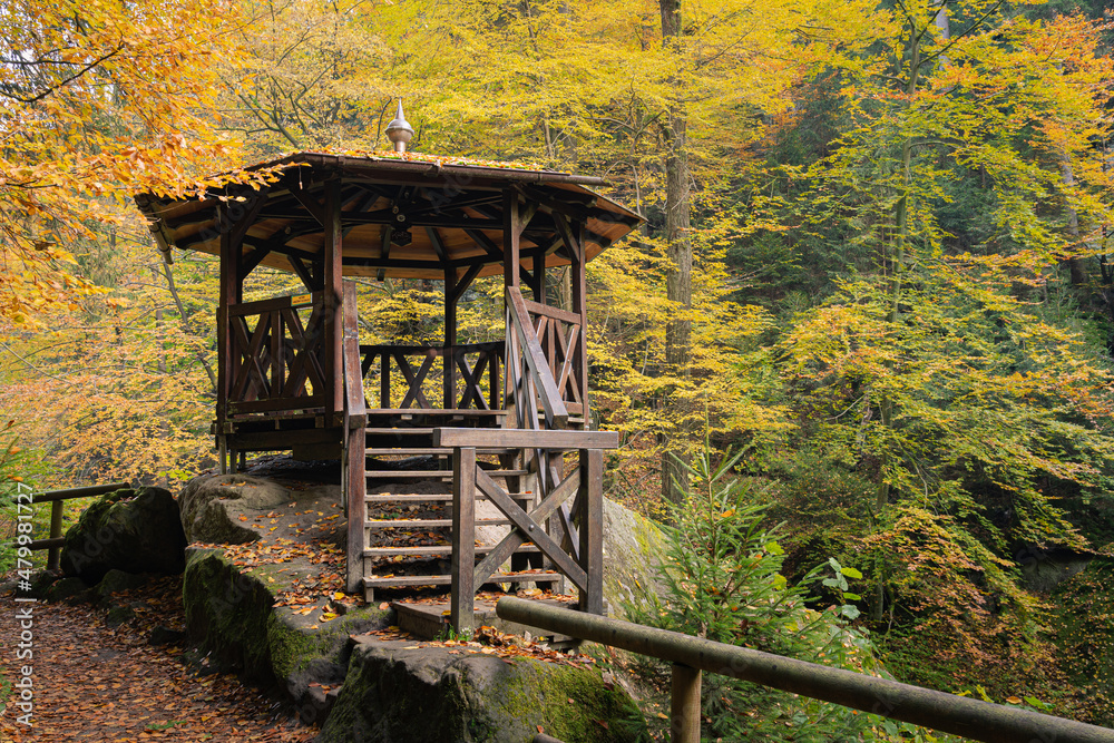 Wooden shelter or gazebo for tourists on a hiking trail in Bohemian Switzerland, Czech republic in autumn. Beautiful autumnal scene