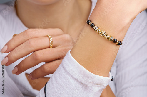 Bracelets. Unisex gold bracelet on woman hand