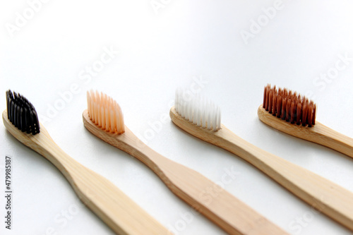 Eco-friendly bamboo toothbrushes on white background. Flat lay  top view  copy space