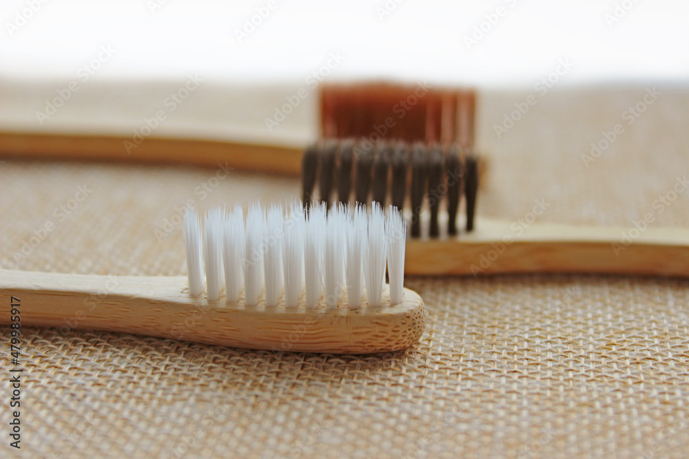 Eco-friendly bamboo toothbrushes on white background. Flat lay, top view, copy space Eco-friendly bamboo toothbrushes on white background. Flat lay, top view, copy space