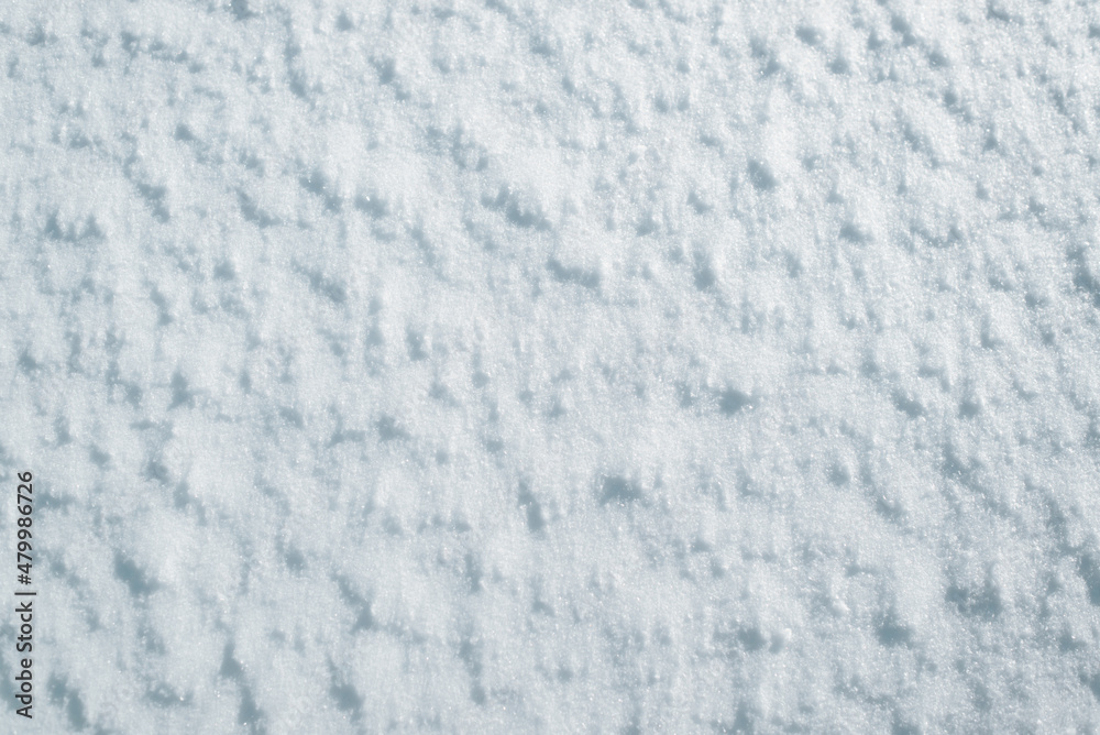 Snow outdoors on sunny winter day, top view close-up. Snow surface texture background