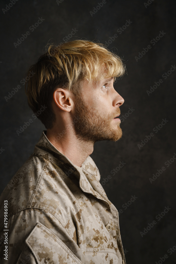 White military man wearing uniform looking upward posing in profile White military man wearing uniform looking upward posing in profile