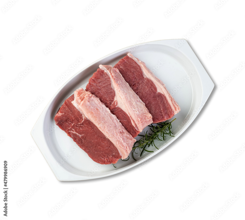 Sliced raw ancho beef, typical argentinian cut, over white plate with seasonings isolated over white background