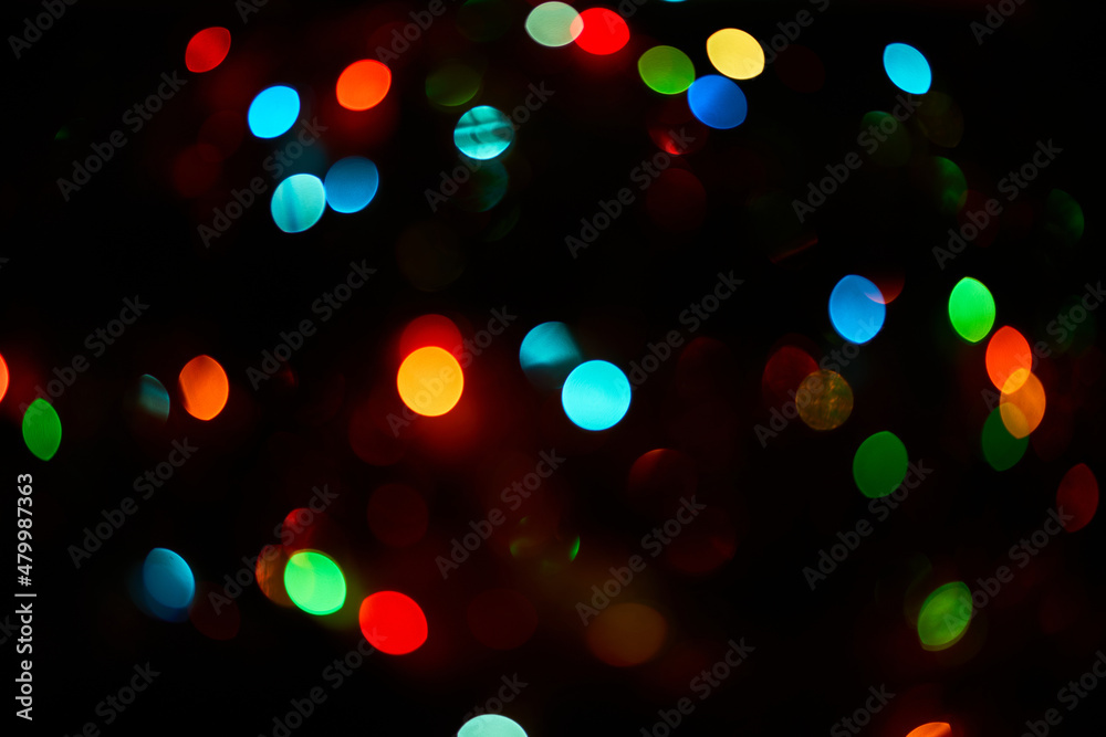 Colorful bokeh abstract background. Glittering stars on dark background. Lights. Garland. Background