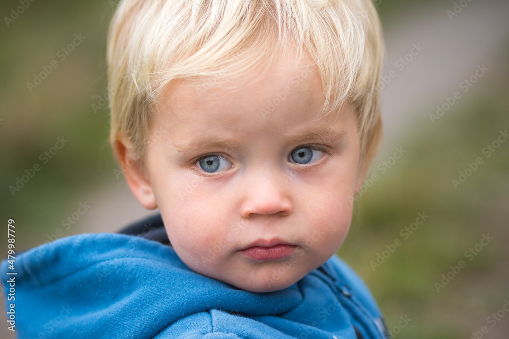 Close up portrait of two years old caucasian kid. Blond child look angry and annoyed. Close up portrait of two years old caucasian kid. Blond child look angry and annoyed.