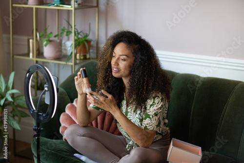 Social influencer filming unboxing for social media photo