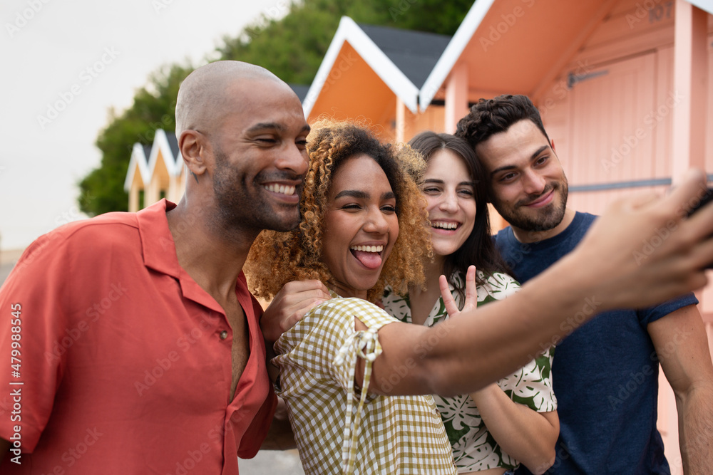 Group of friends taking selfie by the beach on holiday Group of friends taking selfie by the beach on holiday