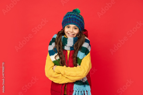 express positive emotion. winter fashion. happy kid with curly hair in hat crossing hands.