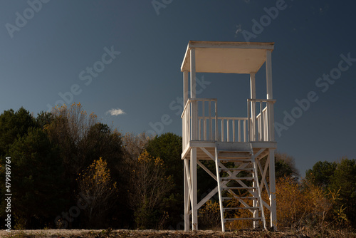 A white lifeguard tower on empty beach photo