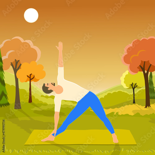 Man European appearance practicing yoga outdoors, standing in extended triangle pose or trikonasana pose, doing exercises outdoors at the field with forest and mountains. 