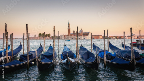 Obraz na plátně Gondolas moored docked on water in Venice
