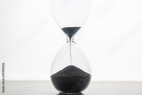 Hourglass on a light background. Time is money. Business solutions in time.