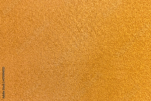 Yellow golden plaster wall abstract pattern stucco surface texture background