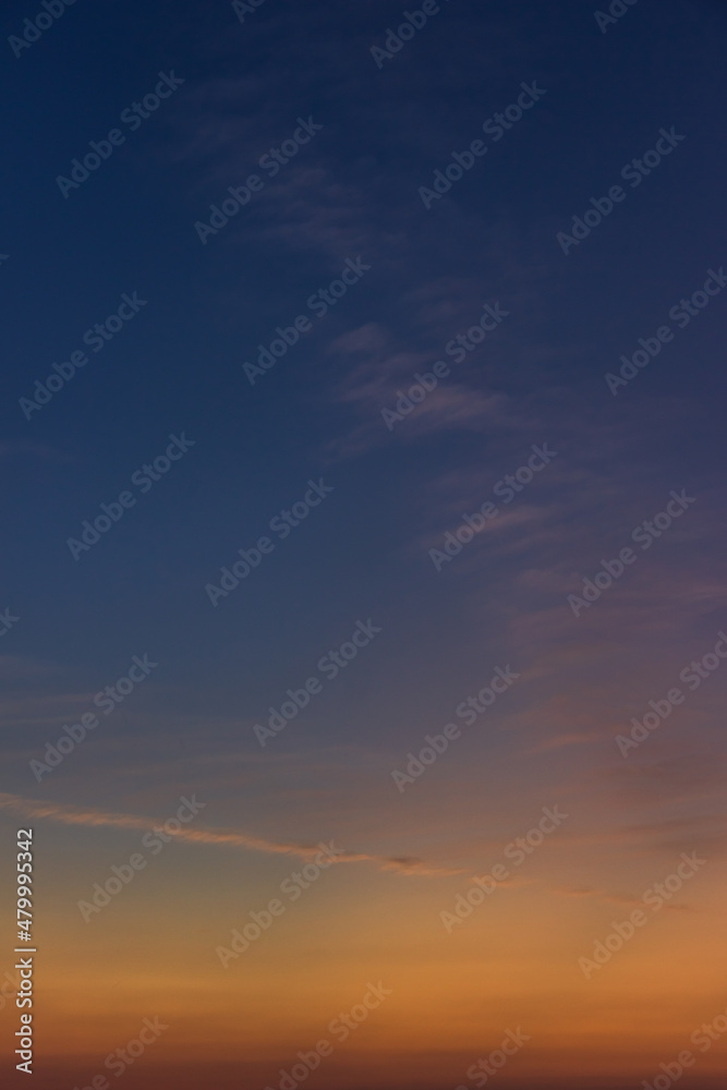 Twilight sky vertical with dark blue and colorful sunlight clouds, Dusk sky background