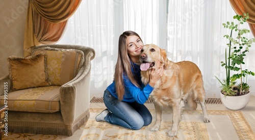 Happy young woman in casual outfit with playful dog, pet and owner