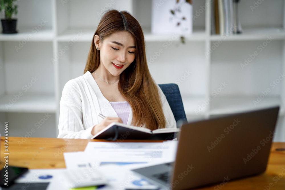 portrait of a businesswoman sitting at her workplace in the office, portrait of a businesswoman sitting at her workplace in the office,