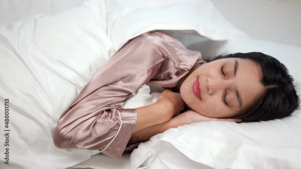 Beautiful asian woman lying in the bed . Young woman sleeping well in comfortable cozy fresh bed on soft pillow white linen. Morning in the bedroom. Health and rest concept. Beautiful asian woman lying in the bed . Young woman sleeping well in comfortable cozy fresh bed on soft pillow white linen. Morning in the bedroom. Health and rest concept.