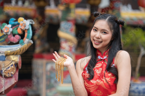 A Chinese woman is happy with her present golden gift Ang Pao on Chinese New Year